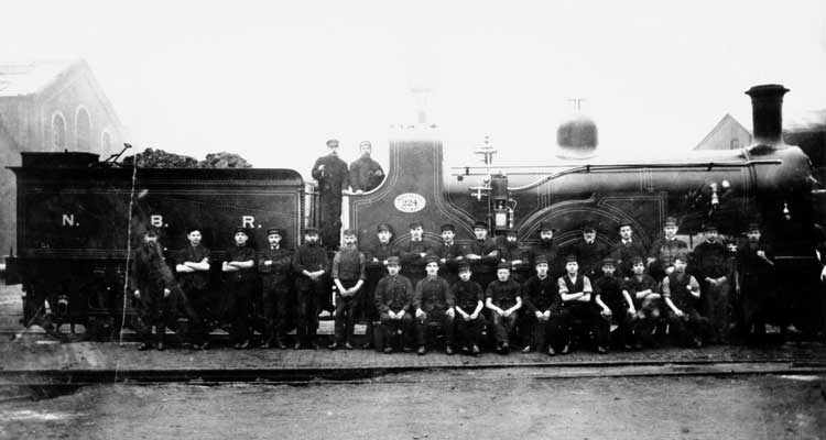 A group photo in front of NBR 4-4-0 No 224